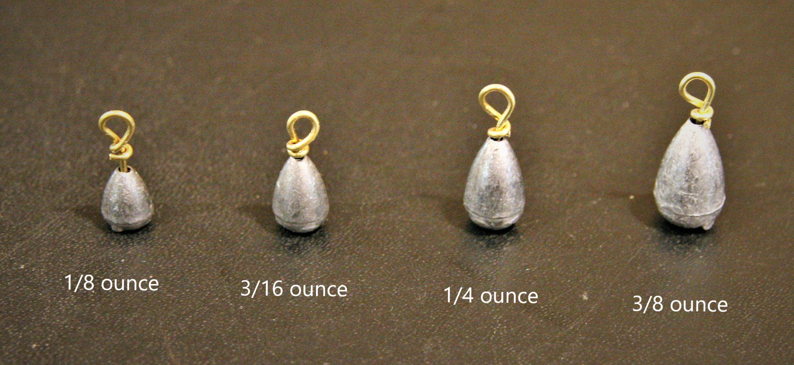 Four different bell sinkers of different weights: 1/8-ounce, 3/16-ounce, ¼-ounce, and 3/8-ounce 